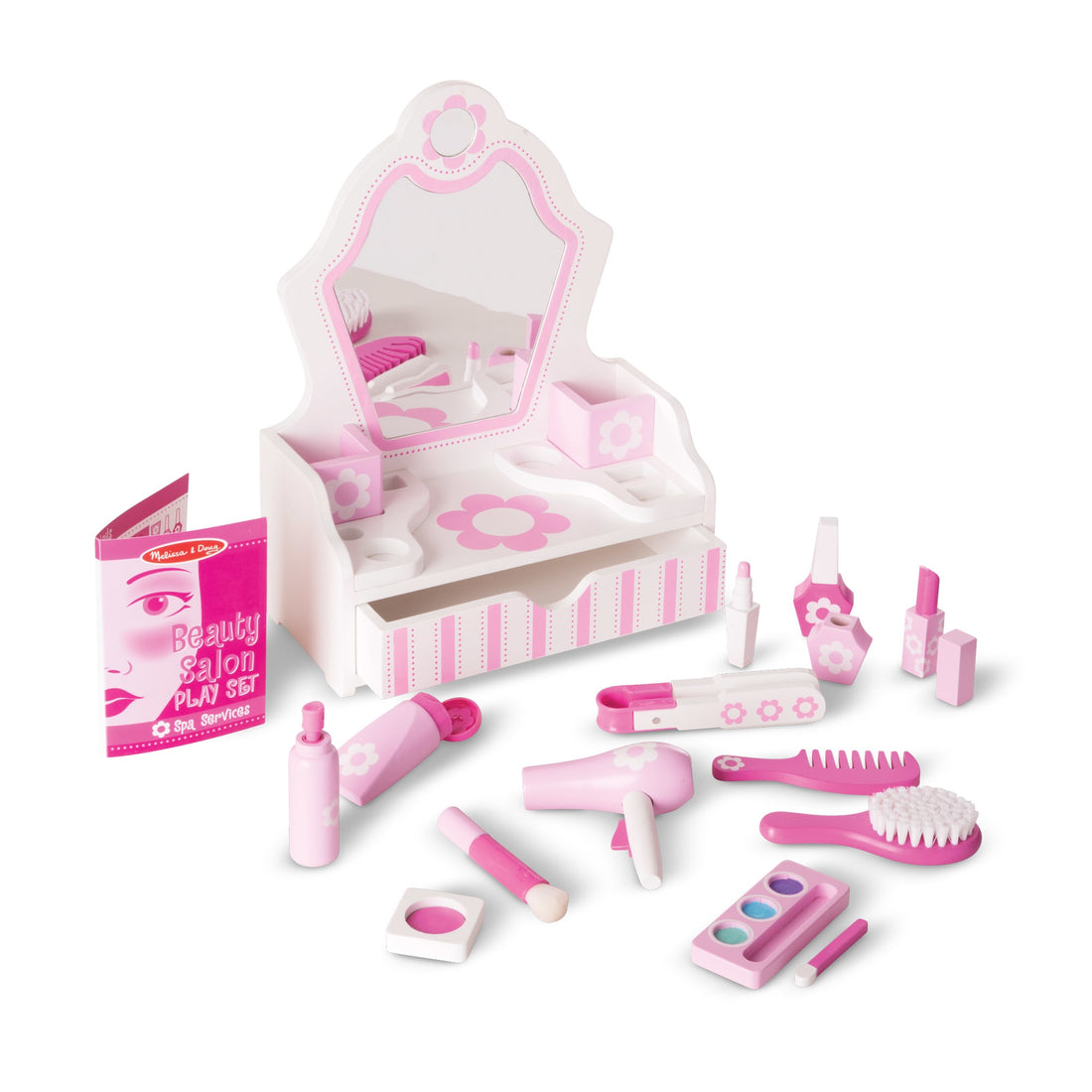 Toy beauty salon set with various pink items in a box on a white background