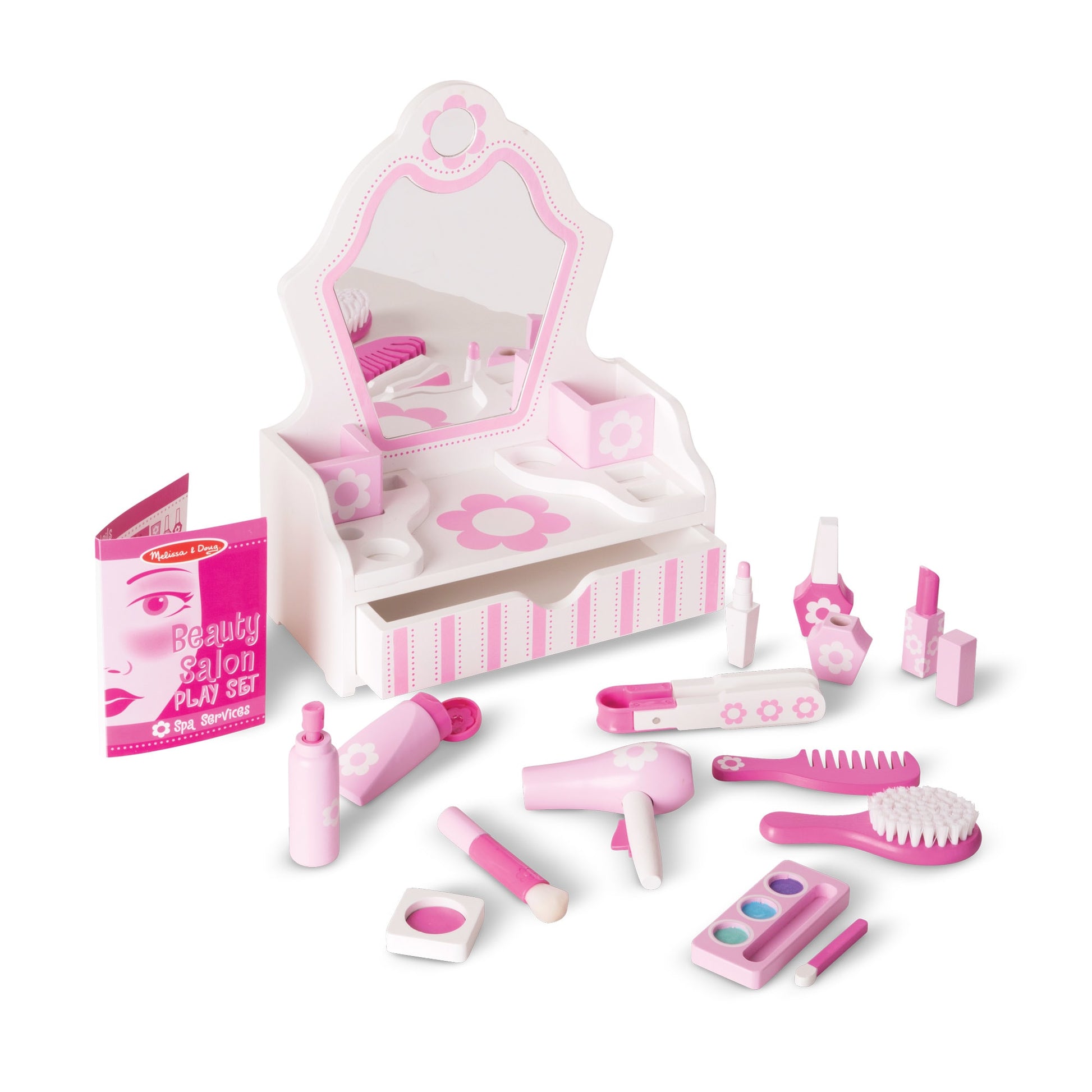 Toy beauty salon set with various pink items in a box on a white background
