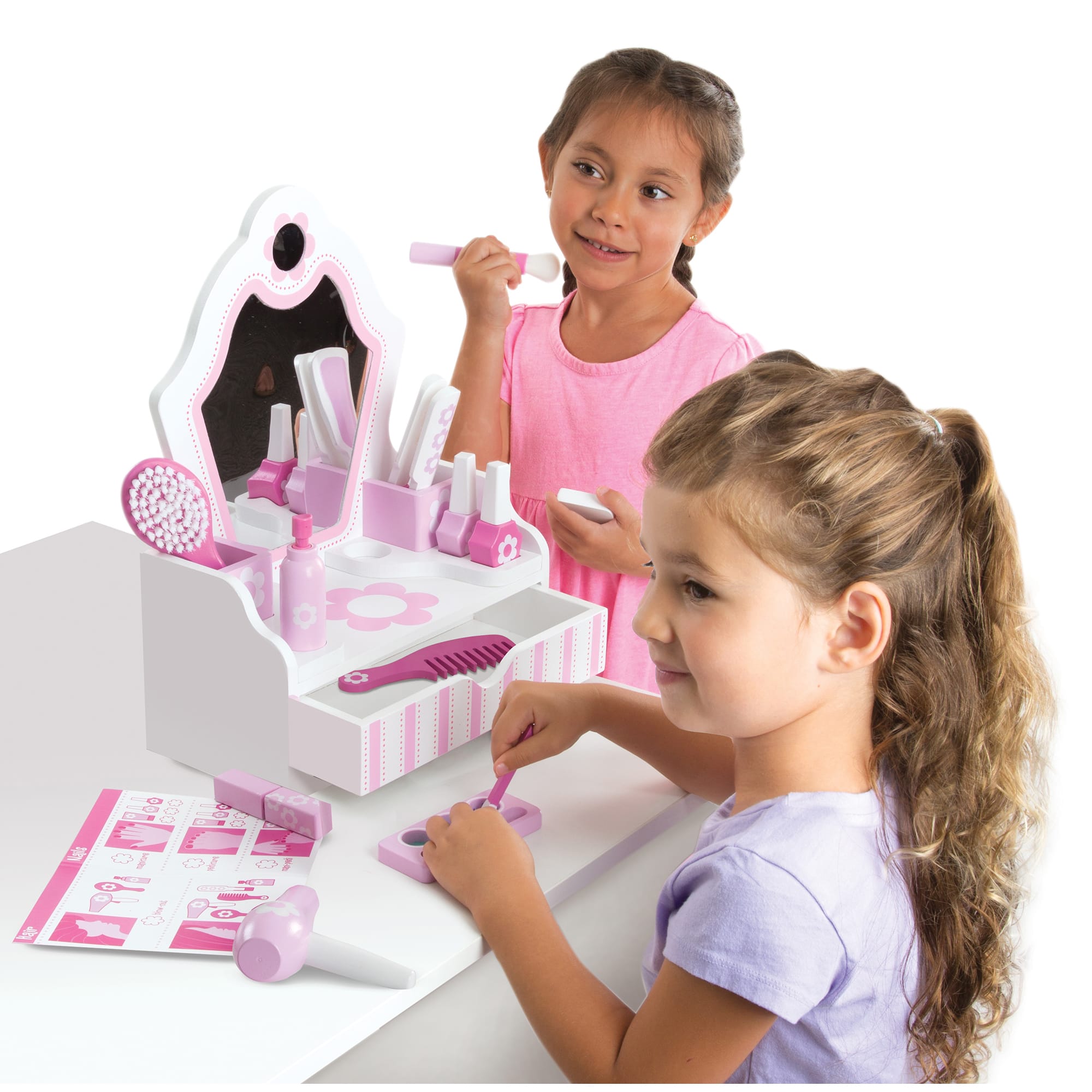 Two children playing with a toy makeup set on a white background