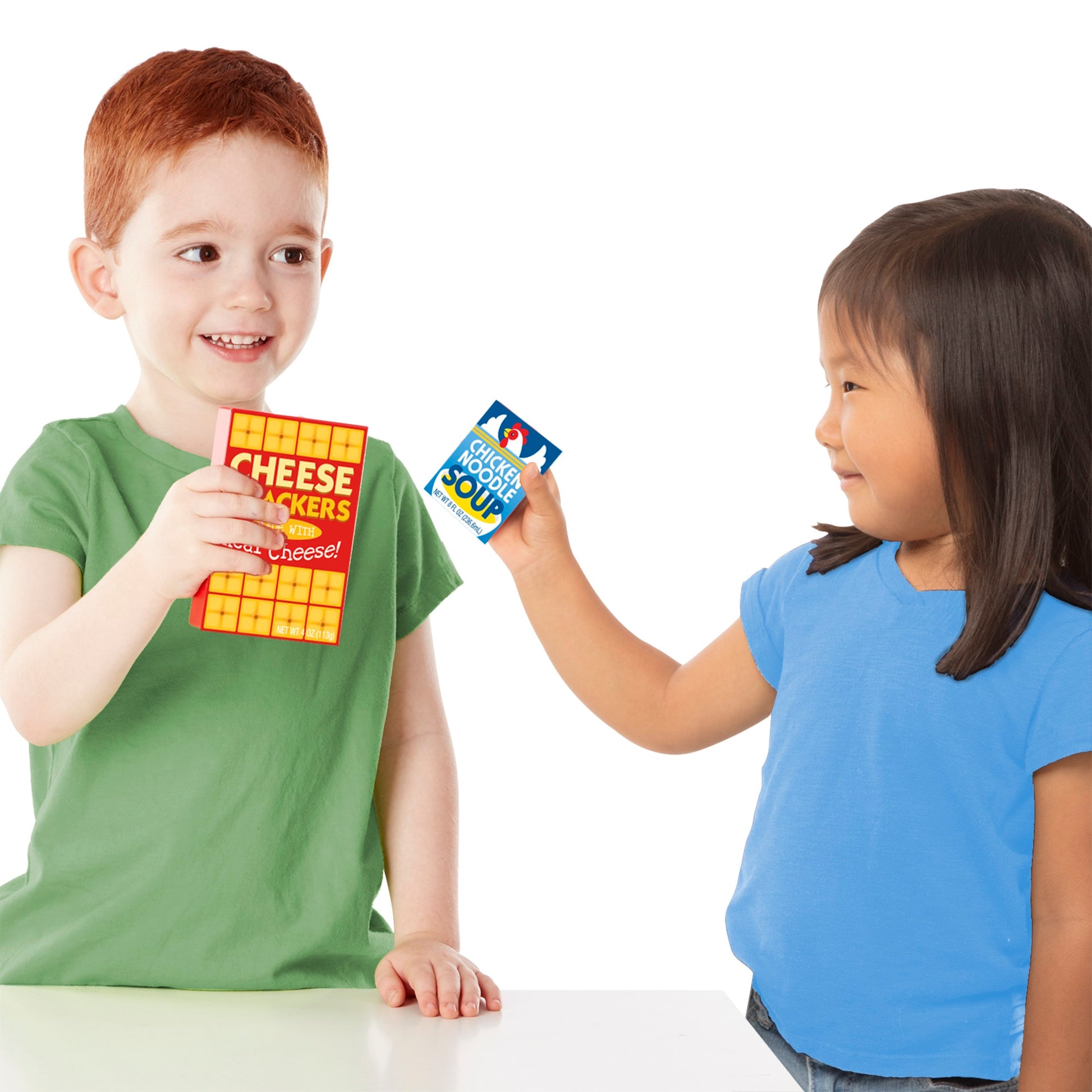 Two children holding cards with a product advertisement on a white background