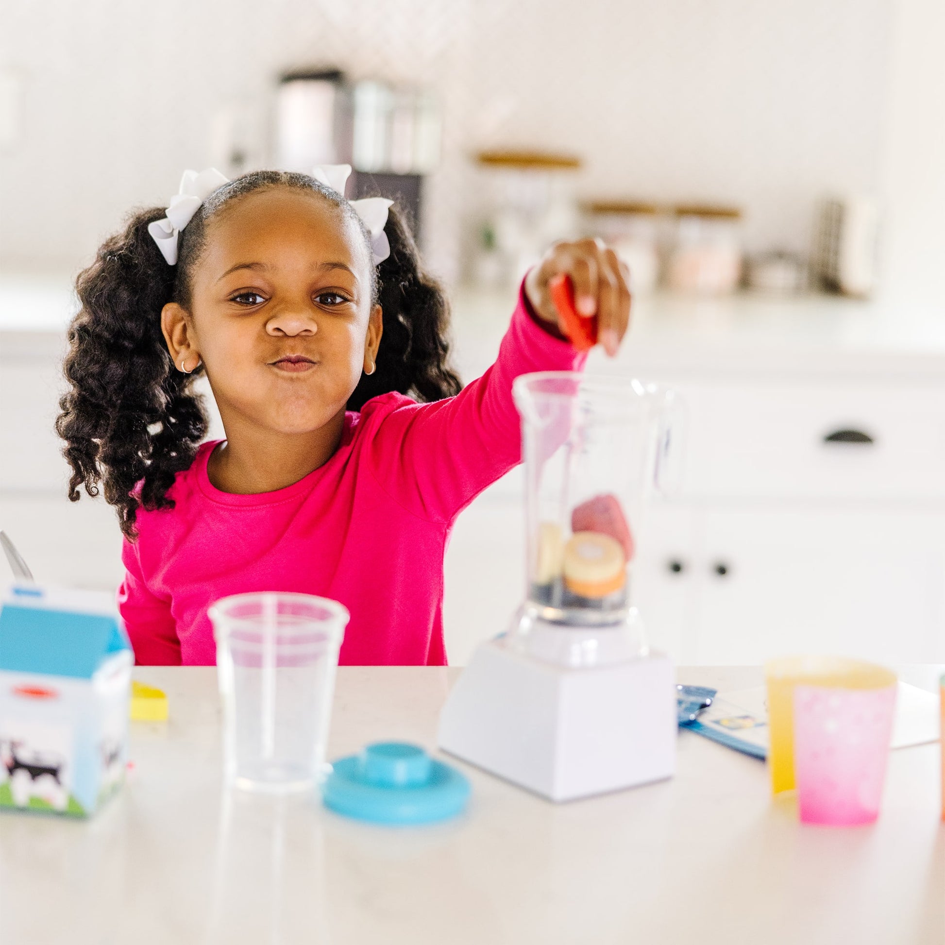 Child playing with a science experiment set up on a table