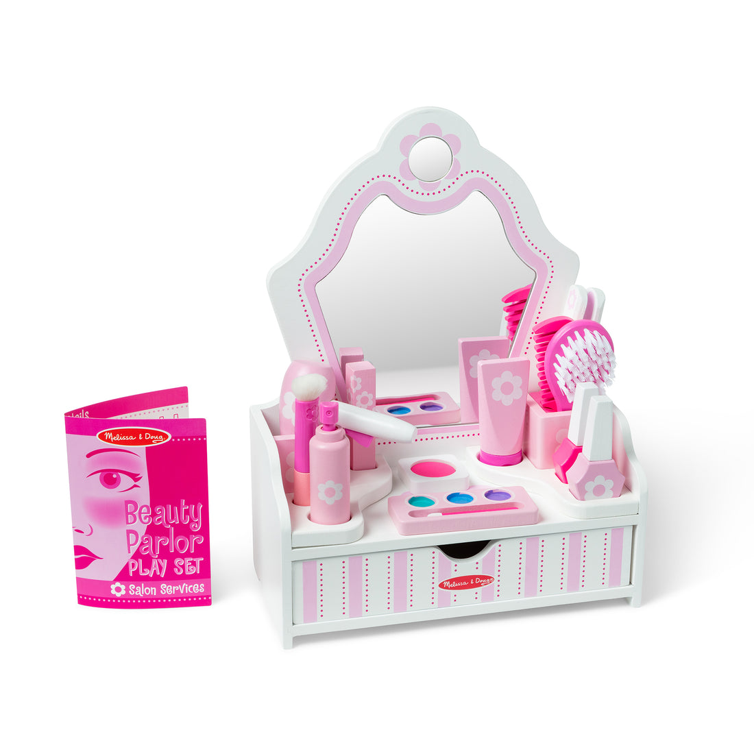 Toy beauty salon set with various pink items in a box on a white background