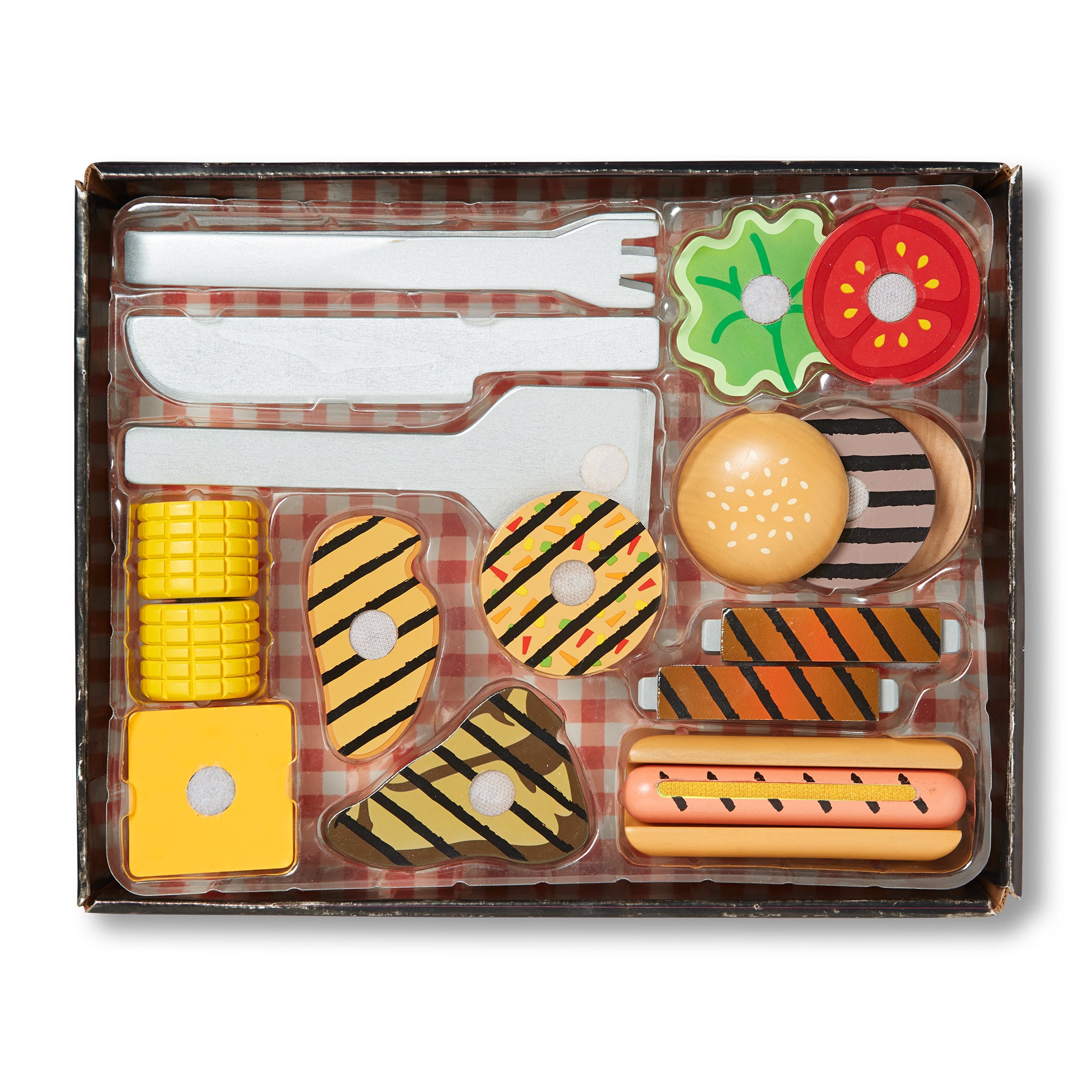 Toy food set with cutlery on a plaid background