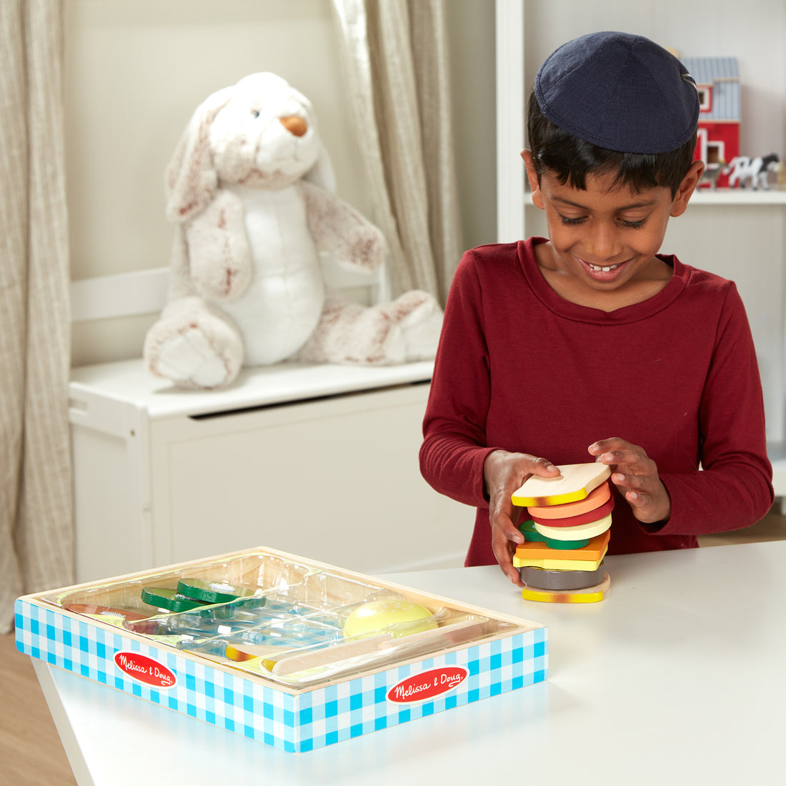 Wooden toy kitchen set with colorful components on a checkered tray, featuring the Melissa & Doug logo.