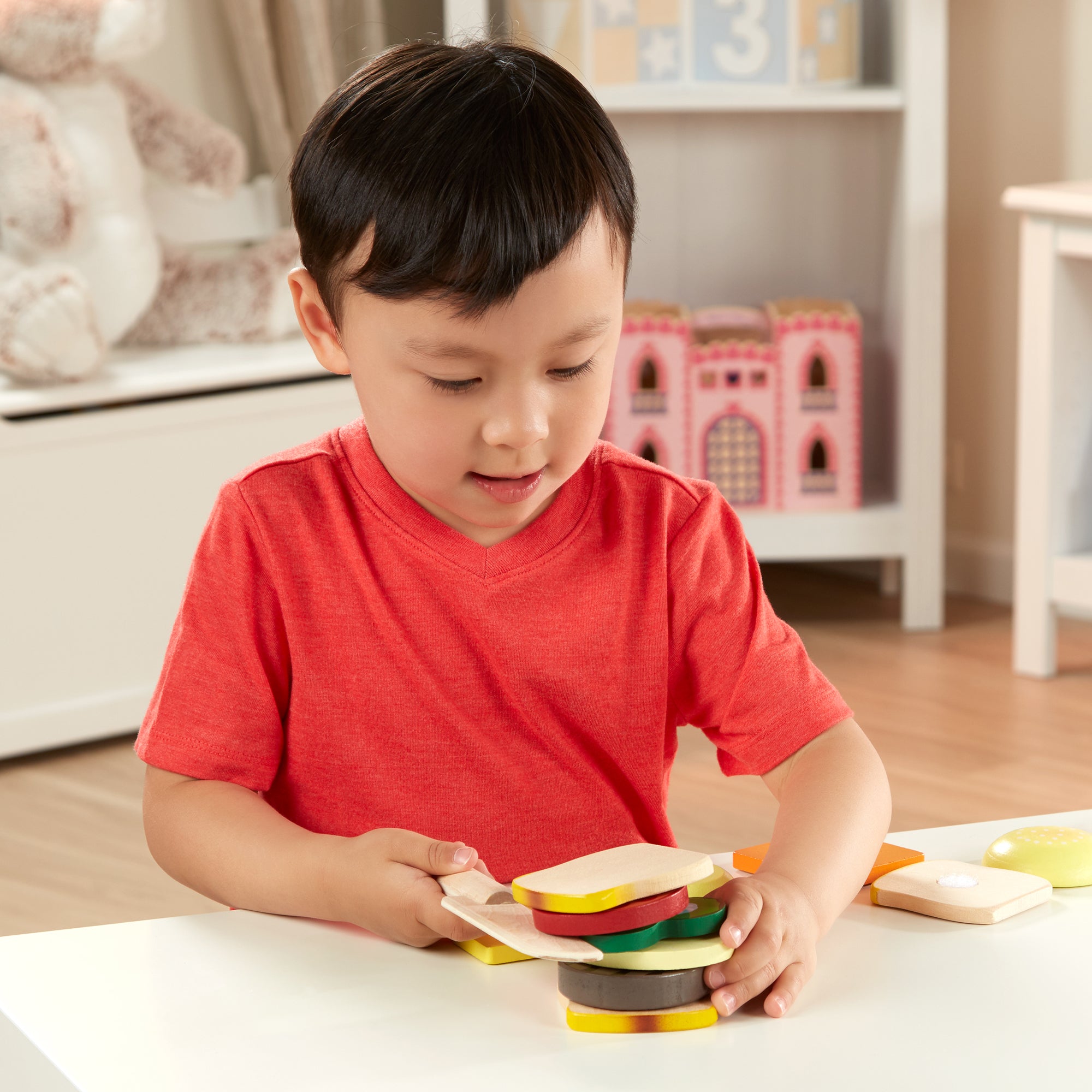 Child playing with colorful stacking toys in a home setting