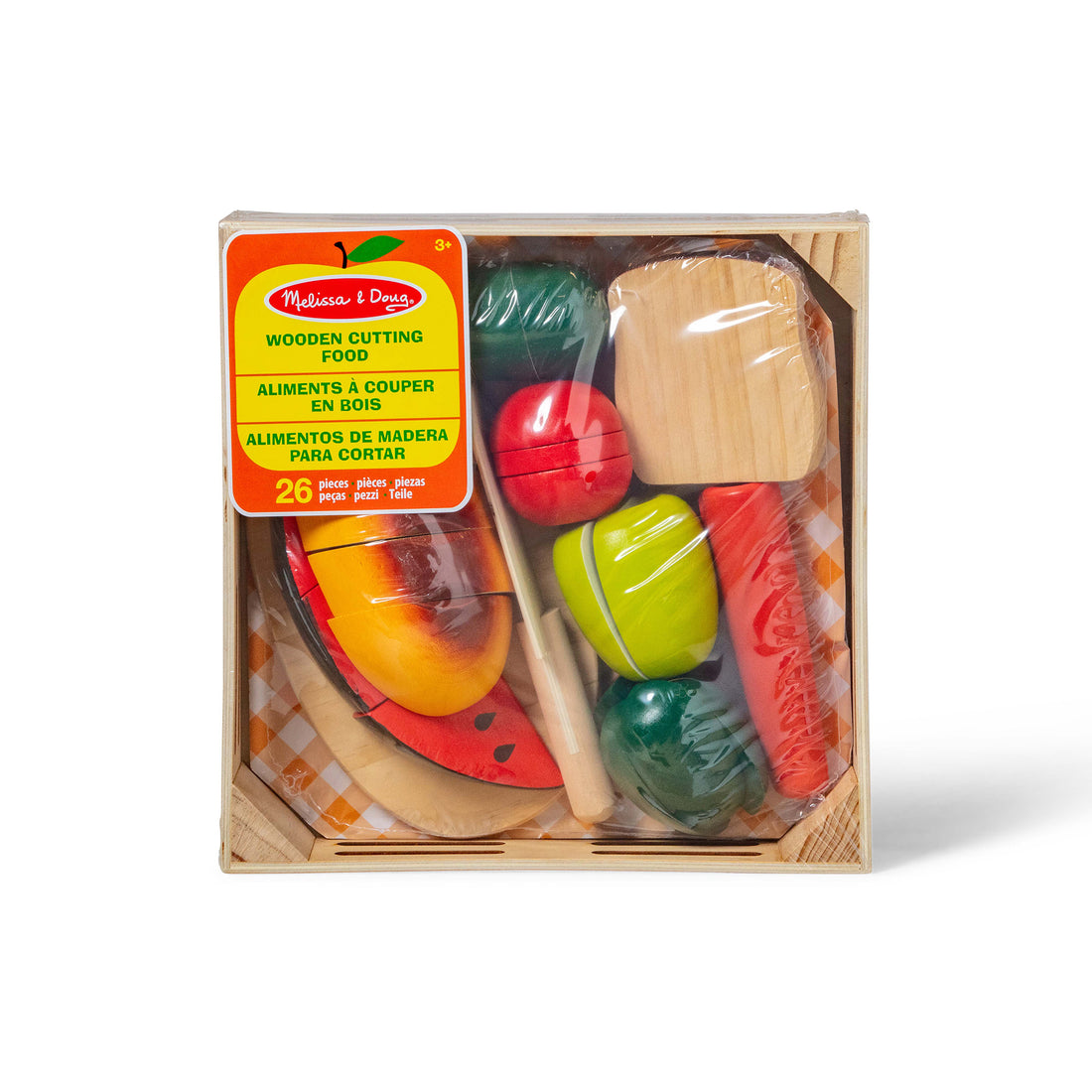 Child playing with wooden toy vegetables and fruits on a table.
