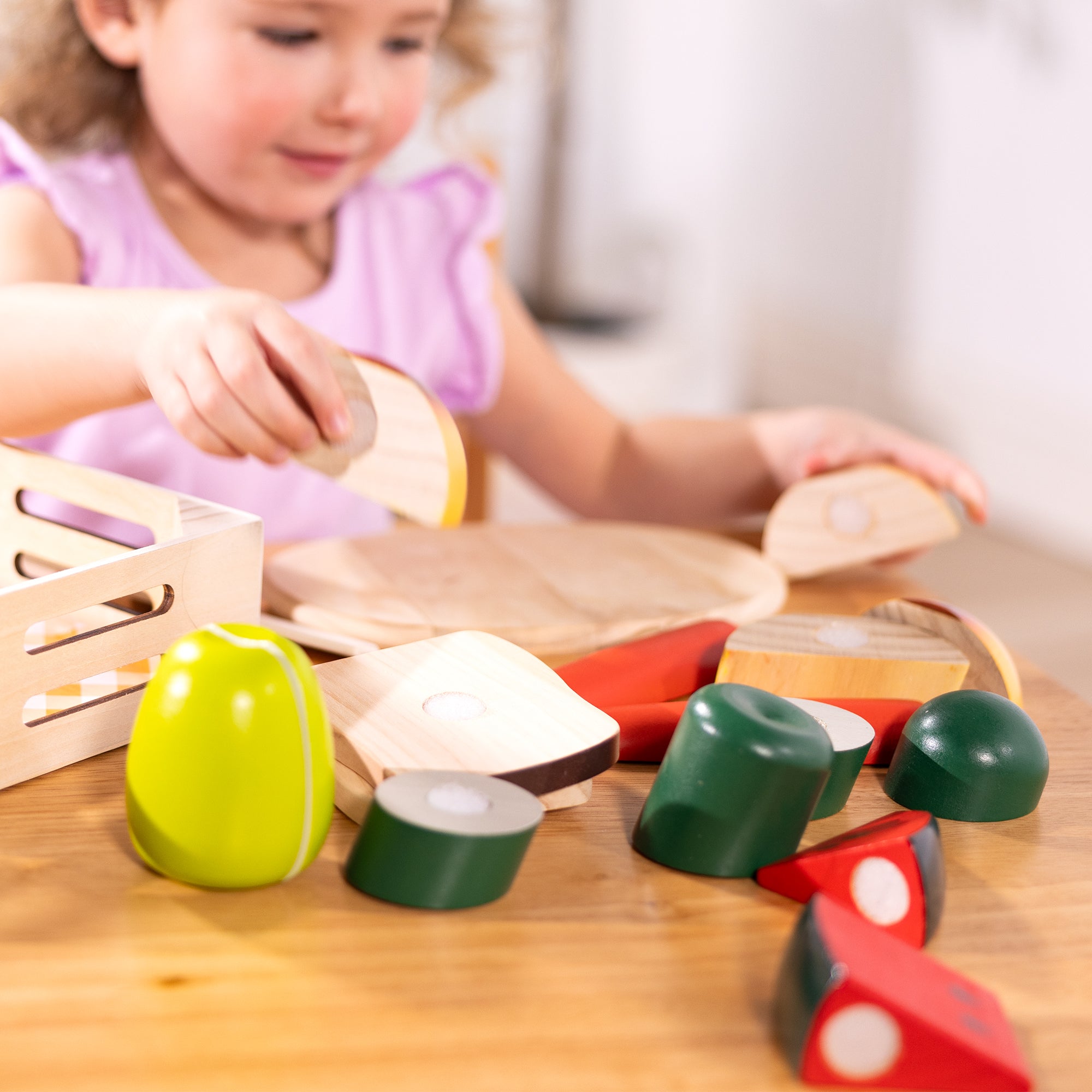 Child playing with wooden toys on a table