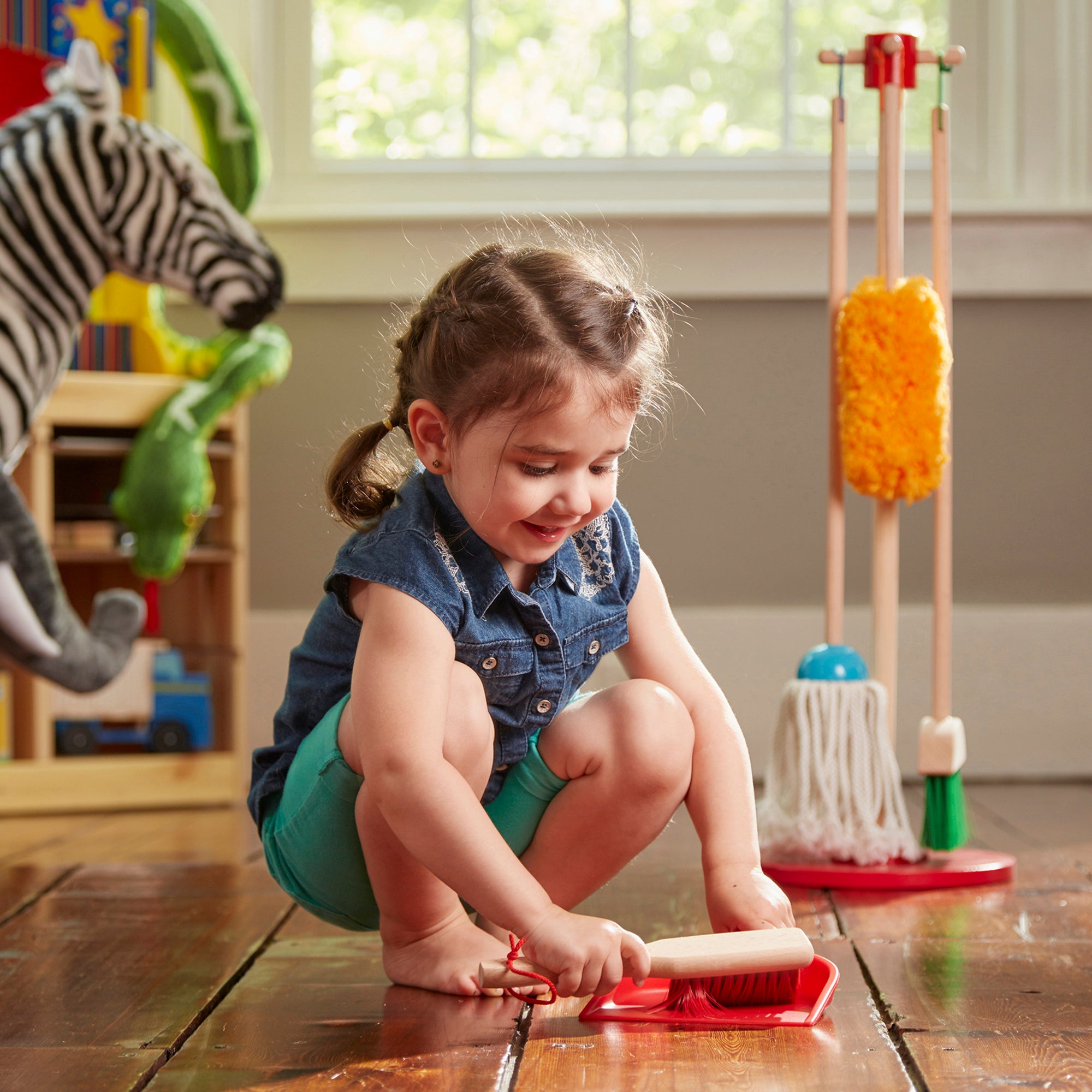 Child playing with a toy in a room filled with toys