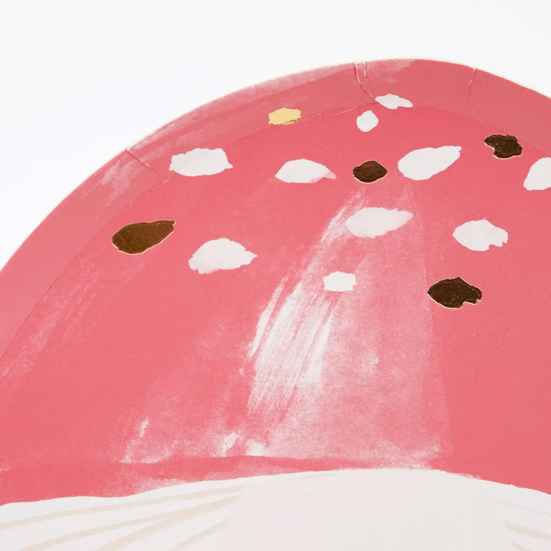 Mushroom-shaped plate with pink cap and white stem on a white background