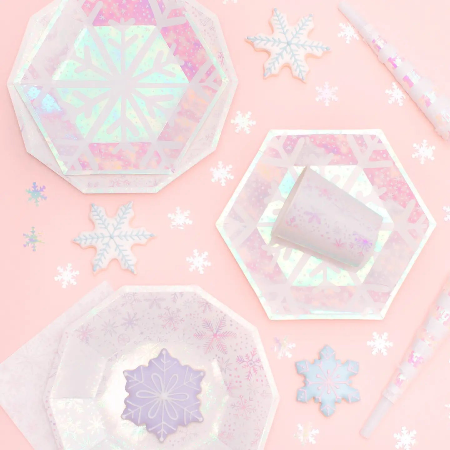 Iridescent snowflake-shaped objects on a pink background
