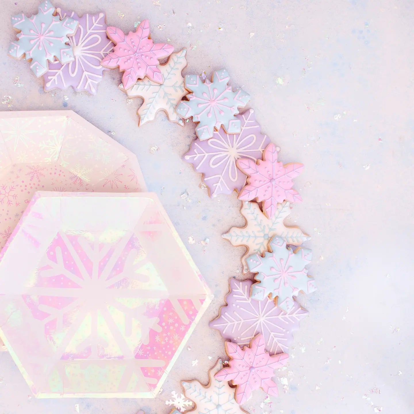 Decorative cookies with pastel snowflake designs on a light background