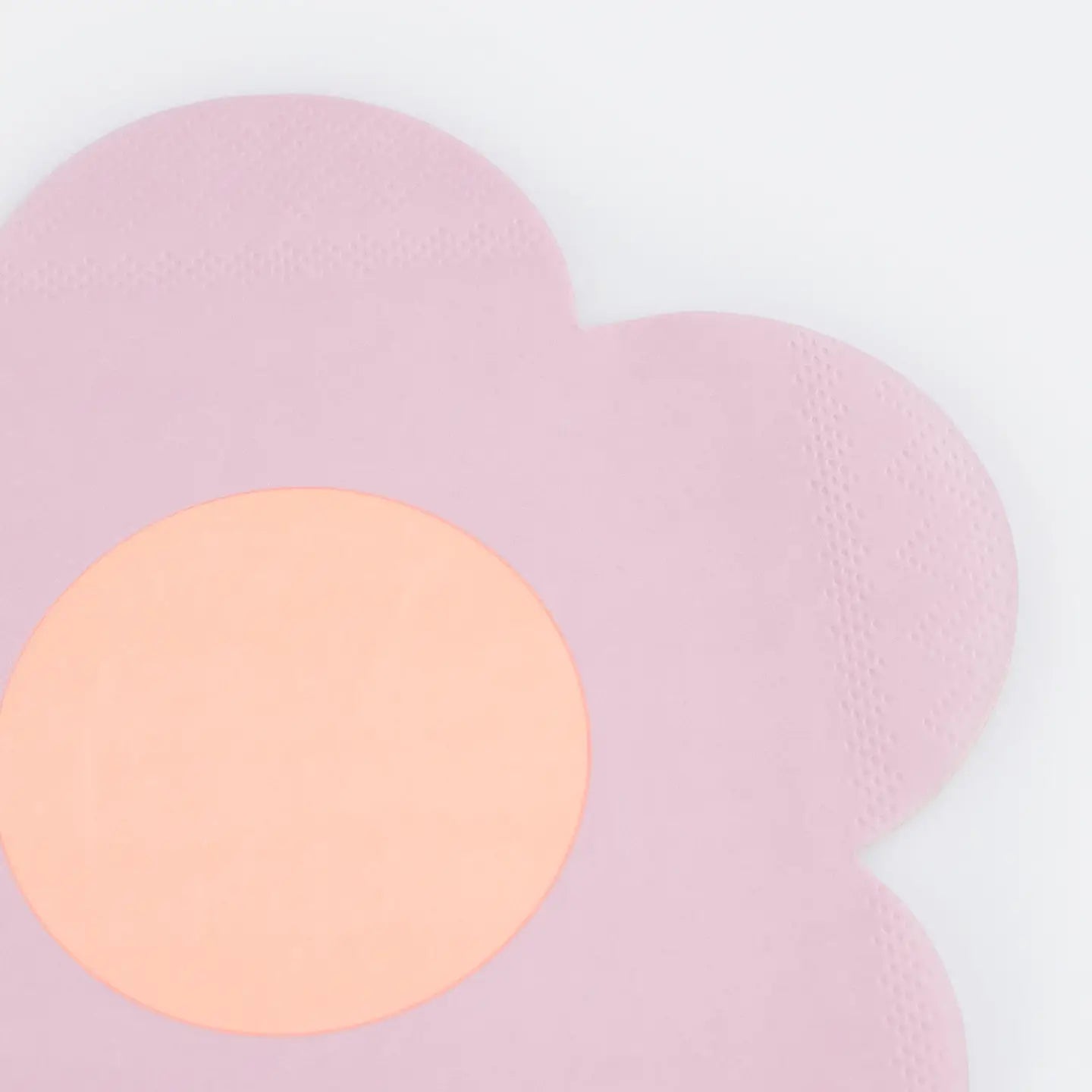 Pink paw-shaped rug with a round beige center on a light gray background