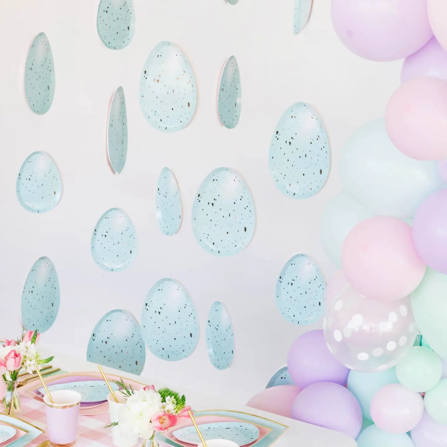 Pastel-colored balloon arch and wall decals on a light background