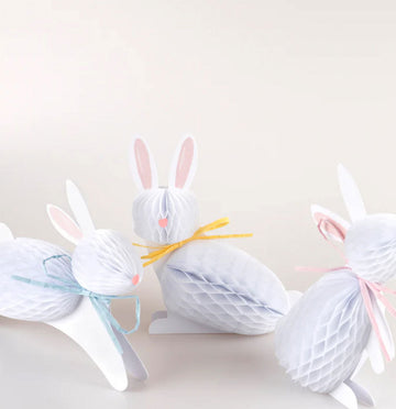 Decorative bunny shapes made from yarn on a white background