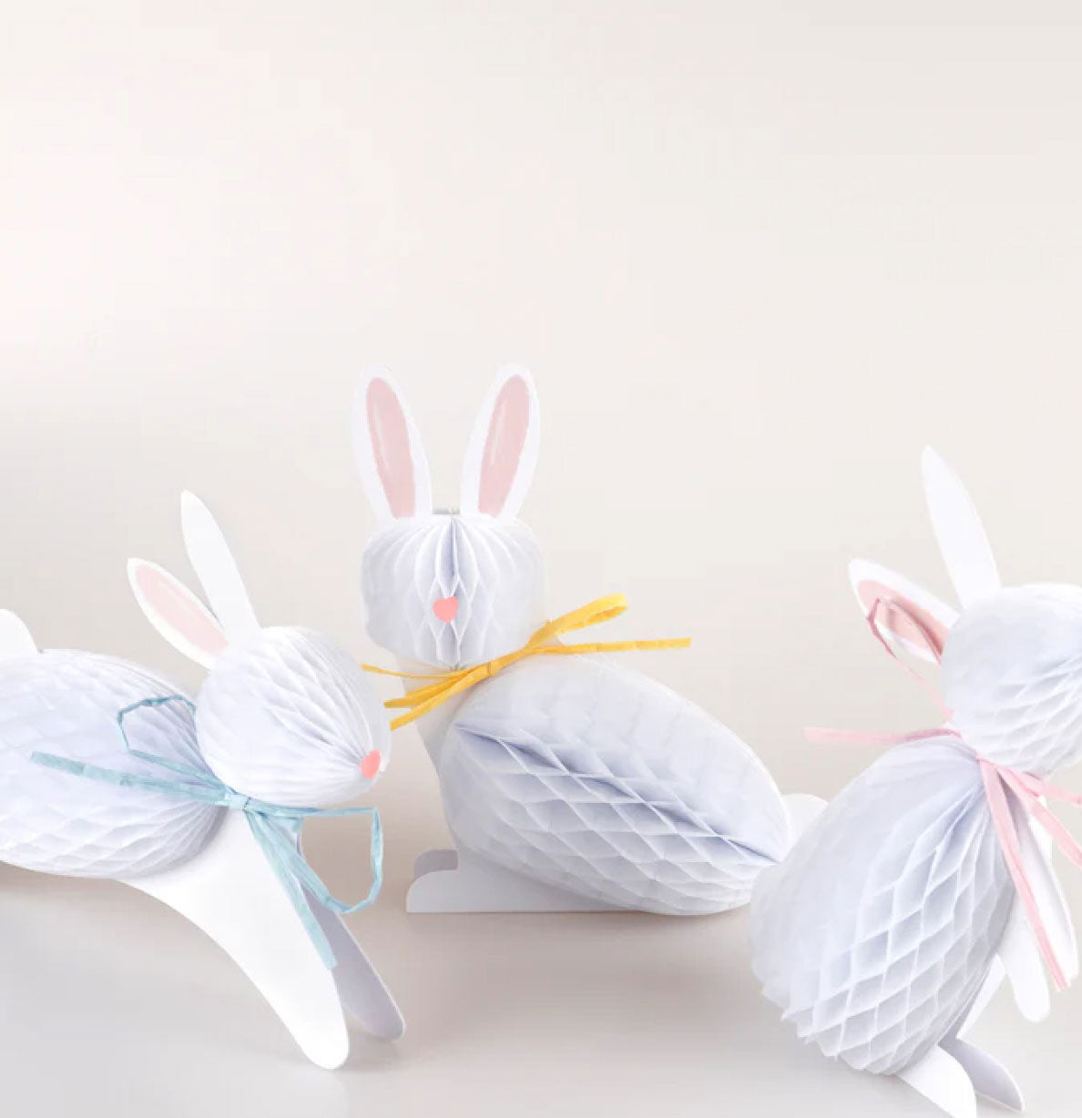 Decorative bunny shapes made from yarn on a white background